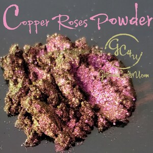 May include: Copper Roses Powder, a fine, shimmery powder with a copper and rose gold colour. The powder is piled high in a mound, showing its texture and sparkle. The text "GC4U Glitter Crafts4U.com" is visible in the lower right corner.
