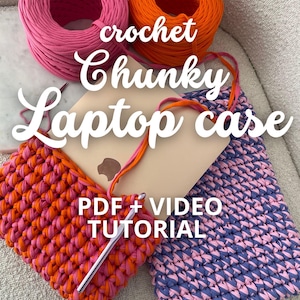 May include: A crochet chunky laptop case in pink and orange yarn with a PDF + VIDEO TUTORIAL written on the case. The yarn balls are also in pink and orange.
