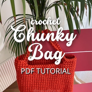 May include: A bright orange crochet bag with a PDF tutorial. The bag is made with chunky yarn and has a simple design.