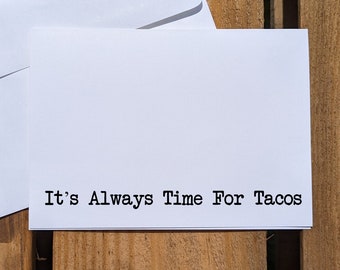 May include: White card with the text "It's Always Time For Tacos" printed in black.