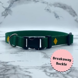 May include: Green dog collar with a yellow diamond design and a black breakaway buckle.
