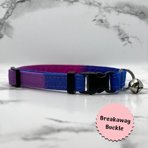 May include: A purple, blue, and pink ombre cat collar with a breakaway buckle and a silver bell.