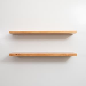 Two Wooden Aged Oak Floating Shelves on a Wall. Heavy duty shelves with floating bracket included.