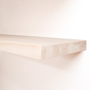 Wooden Unfinished Floating Shelves on a Wall. Heavy duty shelf with floating bracket included.