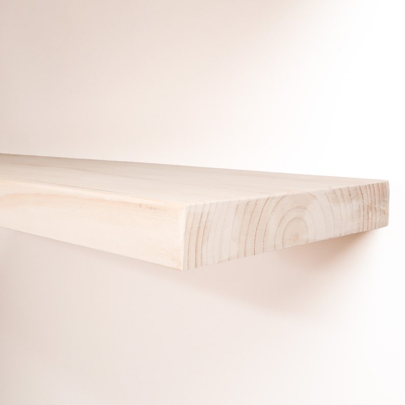 Wooden Unfinished Floating Shelves on a Wall. Heavy duty shelf with floating bracket included.