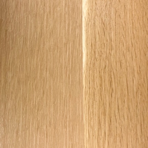 May include: Close-up of a light brown wood surface with a vertical grain pattern. The wood has a natural, unfinished look.