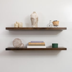Two Wooden Jacobean Floating Shelves on a Wall with Books and Decorations. Heavy duty shelves with floating bracket included.