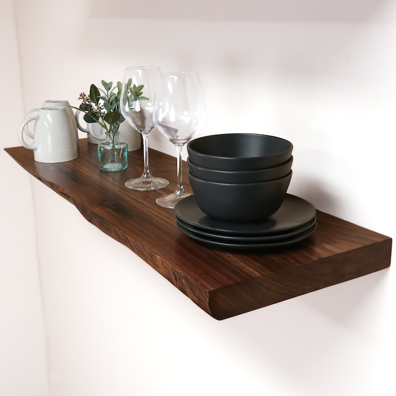 live edge walnut shelf with decorations on a wall