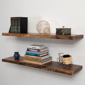 Walnut Live Edge Floating Shelves with Decorations on a Gray Wall
