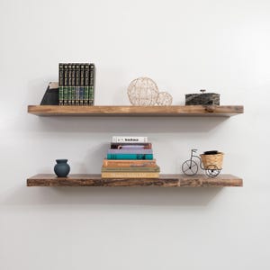 Walnut Live Edge Floating Shelves with Decorations on a Gray Wall