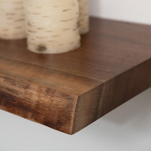 Close up of a walnut live edge floating shelf