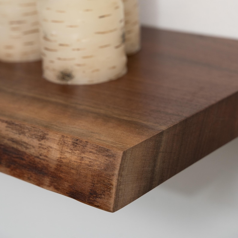 Close up of a walnut live edge floating shelf