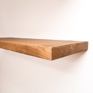 Wooden Aged Oak Floating Shelves on a Wall. Heavy duty shelf with floating bracket included.