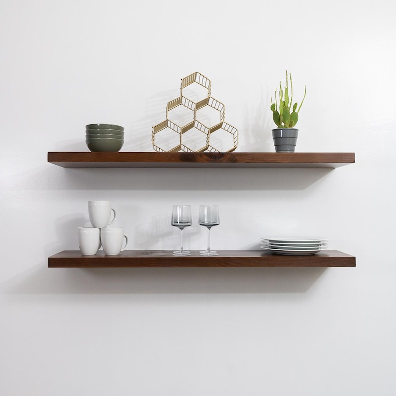 Two Wooden Provincial Floating Shelves on a Wall with Decorations. Heavy duty shelves with floating bracket included.
