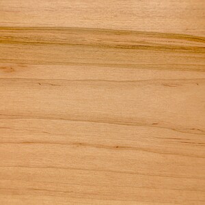 May include: Close-up of a light brown wood grain surface with a natural wood texture.