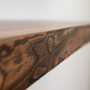 Close up of a live edge walnut floating shelf