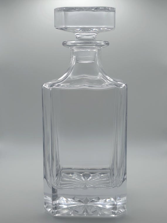 Photo or logo engraving on a whiskey decanter is a genuinely unusual flex — custom portrait or brand mark on glass is a step above standard monogram decanters.