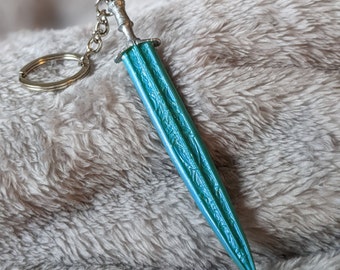 May include: A teal blue sword keychain with a silver chain and a silver handle.