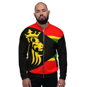 May include: A black bomber jacket with a red and black design. The jacket features a yellow lion with a crown on the left side. The right side has a black, yellow, and green design. The jacket has a zipper closure and black sleeves.