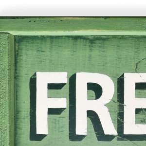 May include: A green wooden sign with white lettering that reads "FRESH". The sign has a distressed look and is perfect for a farmhouse or rustic decor style.