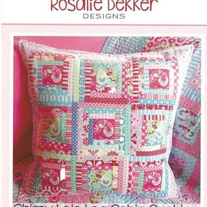 May include: A square, patchwork cushion with a log cabin design. The cushion features a variety of pink, blue, and green patterned fabrics. The text "Chirpy Lola Log Cabin Cushion" is visible at the bottom.