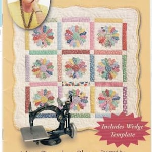 May include: A product package featuring a colorful mini Dresden plate quilt pattern. The package includes a wedge template and features the text "Mini Dresden Plate" and "Quilt in a Day". The image also includes a photo of Eleanor Burns.