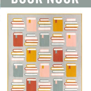 May include: A traditionally pieced quilt pattern titled "Book Nook" featuring a repeating pattern of colorful books. The books are in shades of orange, pink, yellow, and teal, with white pages. The text "BOOK NOOK" is displayed above the quilt pattern.