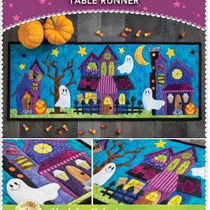 May include: A Halloween-themed table runner with a whimsical design. The runner features colorful haunted houses, smiling ghosts, and a crescent moon against a blue sky. The text "What a BOO-tiful Night" is displayed at the top.