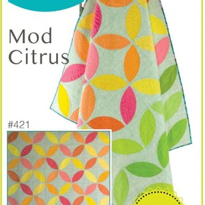 May include: A vibrant quilt with a citrus fruit design. The quilt displays a pattern of overlapping ovals in pink, orange, yellow, and green. The text "Sew Kind of Wonderful" and "Mod Citrus" are visible.