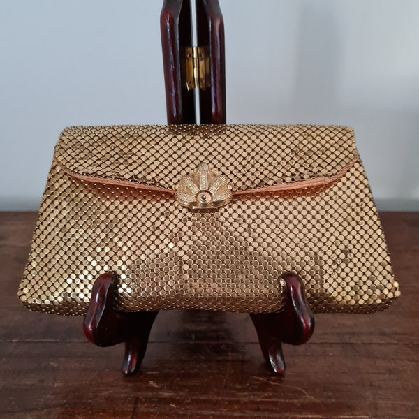 Whiting and Davis Gold mesh clutch bag with sunburst diamonte drop down clasp, apricot lining.