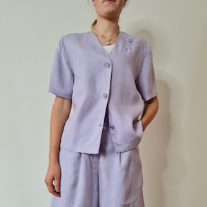 Lilac 2 piece short set, short sleeved jacket with embroidery detail and wide legged shorts with pocket. Size 6-8