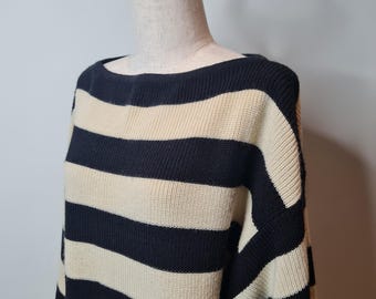 May include: A black and cream striped sweater with a boat neck.