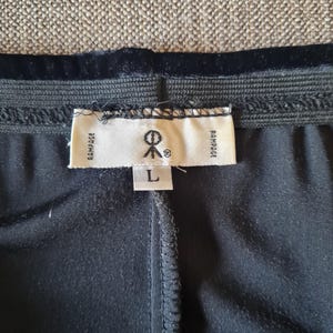 May include: Black pants with a black velvet waistband and a white tag that says "Rampage" and "L" on it.