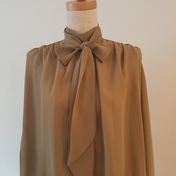 Trent Nathan Gallery, Khaki gathered blouse with pearl buttons.