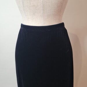 May include: A black velvet skirt with a straight silhouette.
