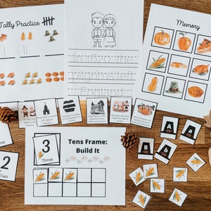 May include: A set of printable Thanksgiving-themed educational activities for kids. The set includes a tally practice sheet, a memory game, a writing prompt, a tens frame activity, and number cards. The activities feature images of pilgrims, turkeys, corn, and pumpkins.