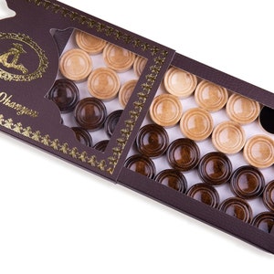 May include: A brown wooden box with a clear plastic window showing a set of draughts. The draughts are in two colours: light brown and dark brown. The box has a gold border and the text "Hrachya Ohanyan" is printed on the front.