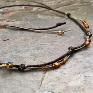 Filigree anklet in earth tones. With colorful glass beads & gold-plated hematite