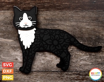 Può includere: Silhouette di gatto nero e bianco con un motivo a mandala. Il gatto ha il viso e il petto bianchi.