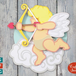 May include: A papercraft cutout of a cupid with blond hair, holding a bow and arrow, with a heart-shaped arrowhead, on a cloud. The cupid is wearing a diaper and has wings. The background is a woodgrain pattern.