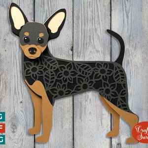 May include: A black and tan papercraft silhouette of a miniature pinscher dog with a floral pattern. The dog is standing on a woodgrain background.