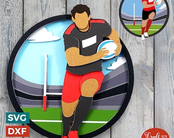 May include: A papercraft illustration of a rugby player running with the ball. The player is wearing a black and red jersey with a white patch on the chest. The background is a layered papercraft design of a stadium with a blue sky and white clouds.
