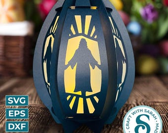 May include: A dark blue paper lantern with a cutout silhouette of a figure and radiating lines, illuminated from within. The lantern has a handle and decorative cutouts. The image includes the text "SVG, EPS, DXF, PNG" and a circular logo that says "Craft with Love, Made with Sarah".