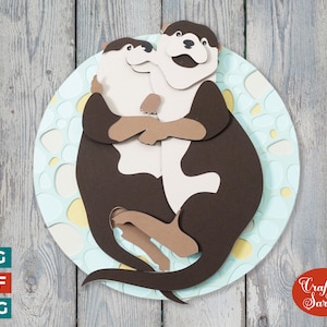 May include: Two brown and white otters are hugging each other on a blue and yellow background. The otters are in a circle shape, and the background is a circle with a pattern of dots.