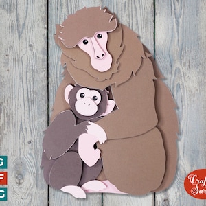 May include: A brown and gray papercraft of a mother monkey holding her baby monkey. The mother monkey is sitting on a wooden background.
