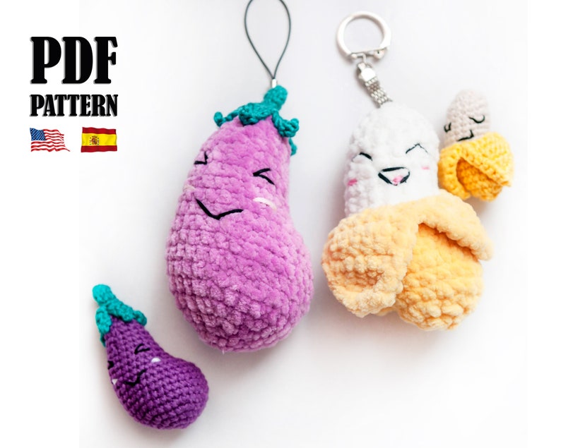 May include: Three crocheted plush toys: a purple eggplant, a yellow banana, and a smaller purple eggplant. The banana and larger eggplant have smiling faces and are attached to key rings. The smaller eggplant is a keychain.