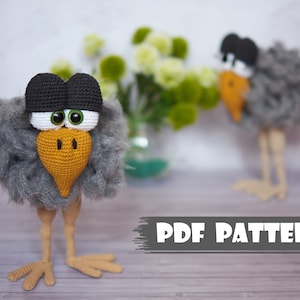 May include: A crochet pattern for a gray and black bird with large eyes and an orange beak. The pattern is available as a PDF download.  PDF PATTERN.
