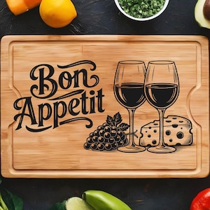 May include: A rectangular wooden cutting board with the words "Bon Appetit" in black script. The board features illustrations of two wine glasses, grapes, and cheese. The board is surrounded by fresh produce.