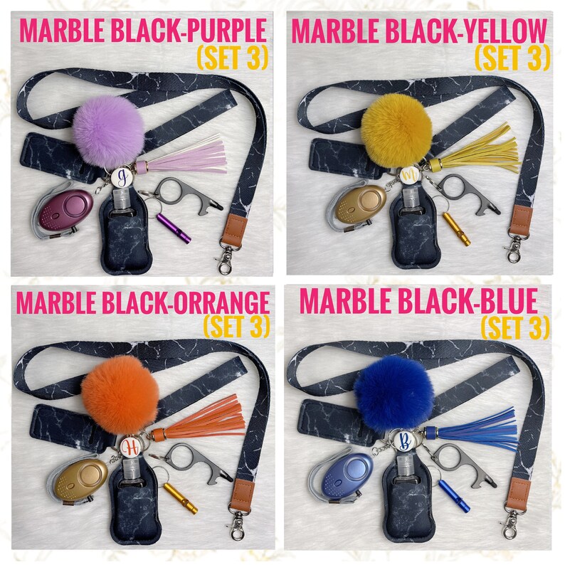 May include: Four keychains with different colored pom-poms, each with a black and white marble pattern lanyard, a small hand sanitizer bottle, a whistle, a key ring, and a small tool. The pom-poms are purple, yellow, orange, and blue.