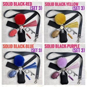 May include: Four sets of keychains with different colored pom-poms. Each keychain includes a black lanyard, a black hand sanitizer holder, a black whistle, a black key ring with a silver key ring, a black self-defense alarm, and a black multi-tool.